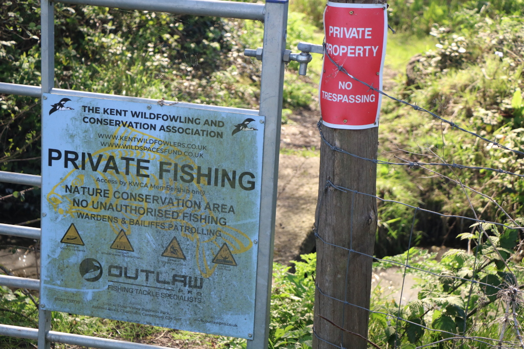 Photo of a gate showing a private property sign and a private fishing area notice.